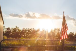 us a flag on gray metal fence during daytime